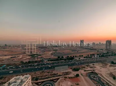 an aerial view of a city with a highway at Comfortable Fully Furnished Studio l Ideal Living Space in Dubai