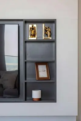 a shelf with a mirror and a picture on it at Frank Porter - Forte Tower 1 in Dubai