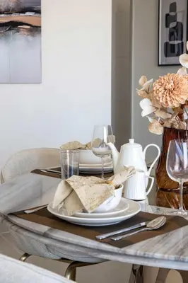 a dining room table with a plate of food on it at Frank Porter - Forte Tower 1 in Dubai