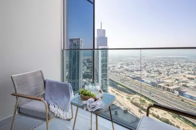 a room with a table and chairs and a large window at Frank Porter - Forte Tower 1 in Dubai