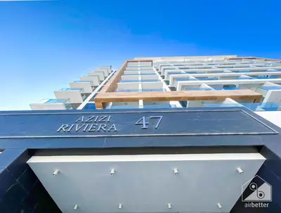 a building with a blue roof on top of it at Urban Charm Studio with Balcony in Riviera in Dubai