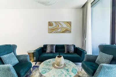 a living room with blue couches and a table at Panoramic Sea & Palm Views 2BR Address Beach Resort JBR in Dubai