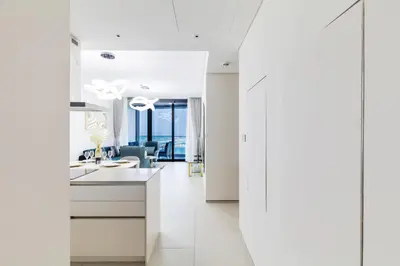a white kitchen with a sink and a mirror at Panoramic Sea & Palm Views 2BR Address Beach Resort JBR in Dubai