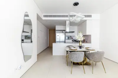 a kitchen and dining room with a table and chairs at Panoramic Sea & Palm Views 2BR Address Beach Resort JBR in Dubai