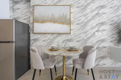 a dining room with a table and chairs at Charming Studio in Luma 22, Jumeirah Village Circle in Dubai