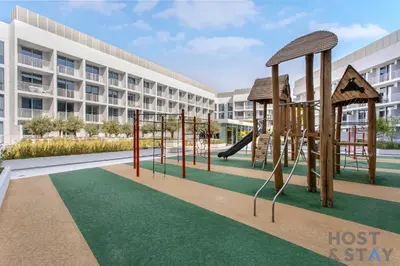 a playground in front of a building at Charming Studio in Luma 22, Jumeirah Village Circle in Dubai