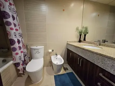 a bathroom with a toilet and a sink and a mirror at Stunning Apartment - High Floor - Canal View - Goldcrest Exectutive Tower in Dubai