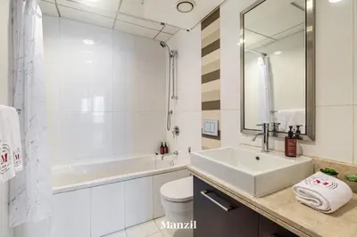 a bathroom with a sink and a tub and a toilet at Stylish 2BR with Burj Khalifa View near Dubai Mall in Dubai