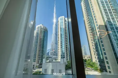 a view of a city skyline from a window at Stylish 2BR with Burj Khalifa View near Dubai Mall in Dubai