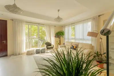 a living room with a couch and a chair at Ramadan Staycation offers Miracle Home Haven in Dubai