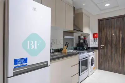 a kitchen with a stove and a washer and dryer at Bloomfields Stu In Carson in Dubai