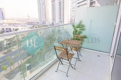 two chairs and a table on a balcony at Bloomfields Stu In Carson in Dubai