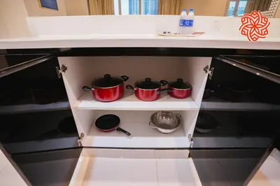 a kitchen with two pots and pans on a shelf at Alashrafia Saray- Classy 1BDR apartment in Canal Views in Dubai