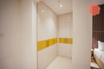 a bedroom with white walls and a walk in closet at Alashrafia Saray- Classy 1BDR apartment in Canal Views in Dubai