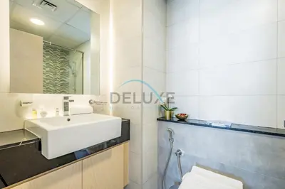 a bathroom with a white sink and a mirror at Lovely 1BR in Binghatti Avenue Al Jaddaf by Deluxe Holiday Homes in Dubai