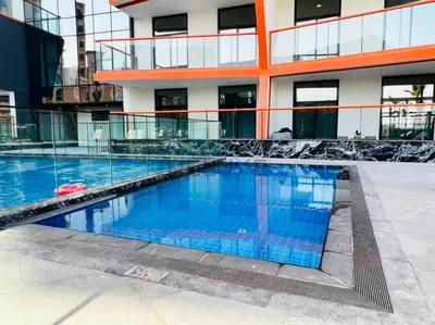 a swimming pool in front of a building at Lovely 1BR in Binghatti Avenue Al Jaddaf by Deluxe Holiday Homes in Dubai