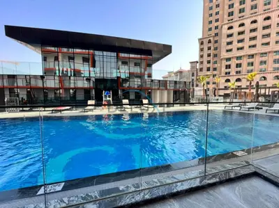 a large swimming pool in front of a building at Lovely 1BR in Binghatti Avenue Al Jaddaf by Deluxe Holiday Homes in Dubai