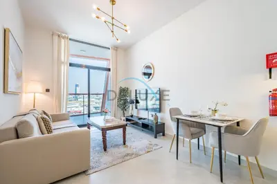 a living room with a couch and a table at Lovely 1BR in Binghatti Avenue Al Jaddaf by Deluxe Holiday Homes in Dubai