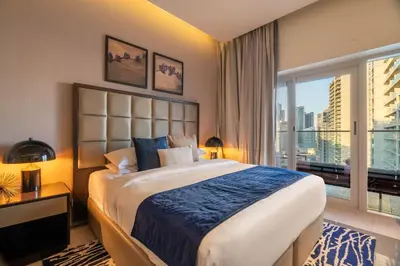 a bedroom with a large bed and a large window at GuestReady - Charming studio in Business Bay in Dubai