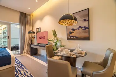 a living room with a table and chairs and a desk at GuestReady - Charming studio in Business Bay in Dubai