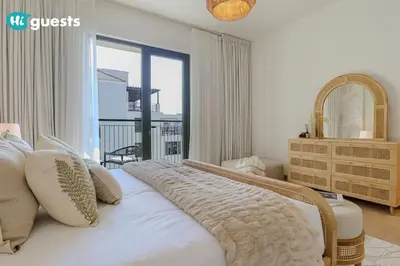 a bedroom with a large white bed with a large window at HiGuests - Beachfront Living Stunning 4 BR with Maid's Room in Dubai