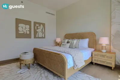 a bedroom with a large bed with white sheets and pillows at HiGuests - Beachfront Living Stunning 4 BR with Maid's Room in Dubai