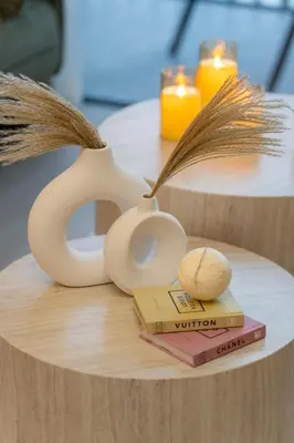 a table topped with two tables with books and candles at luxury Santorini studio style in Dubai