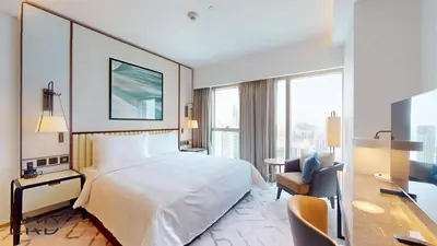 a hotel room with a large bed and a desk at Classy & Cozy 2BR Harbour Point in Dubai