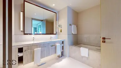 a bathroom with a sink and a tub and a mirror at Classy & Cozy 2BR Harbour Point in Dubai