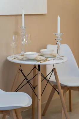 a white table with two candles on top of it at luxury Venice holiday home in Dubai