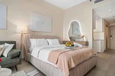 a bedroom with a large bed with a bowl of fruit on top at luxury Venice holiday home in Dubai