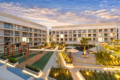 an apartment building with a courtyard at night at luxury Venice holiday home in Dubai