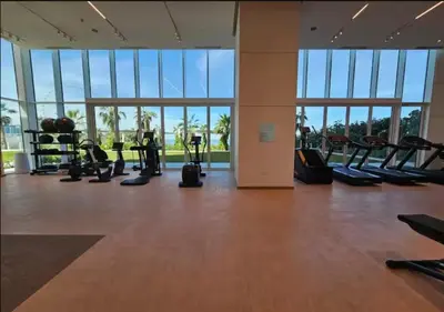a gym with treadmills and exercise equipment in a building at Lovely 1BD apartment in La Vie Dubai in Dubai