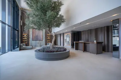a large lobby with a tree in a large planter at Spacious and Modern Studio -Great Facilities in Dubai