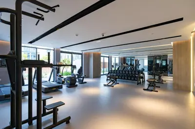 a gym with rows of treadmills and exercise equipment at Spacious and Modern Studio -Great Facilities in Dubai