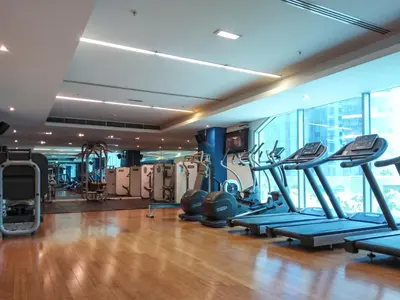 a gym with treadmills and ellipticals in a building at Marina Royale 3 Bedroom Apartment I Luxe Marina Harbour & Yacht Club Views I Nearby to a Beach I Free Pool, Gym, Wi-Fi and Parking I by Meerak in Dubai