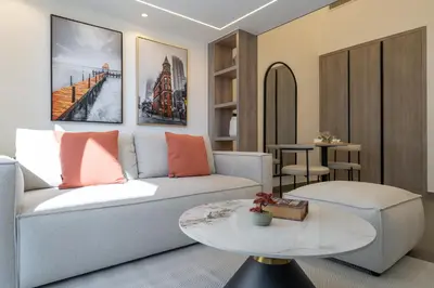 a living room with a couch and a table at Trendy Loft Studio in Oxford Terrace JVC in Dubai