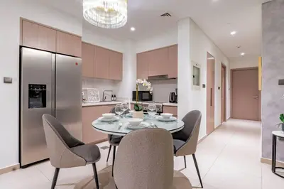 a kitchen and dining room with a table and chairs at Dubai Opera - Luxury 2 Bedroom Apartment - Near Burj Khalifa in Dubai