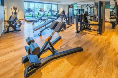 a gym with several treadmills and cardio machines at Dubai Opera - Luxury 2 Bedroom Apartment - Near Burj Khalifa in Dubai