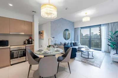 a kitchen and living room with a table and chairs at Dubai Opera - Luxury 2 Bedroom Apartment - Near Burj Khalifa in Dubai