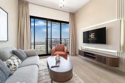 a living room with a couch and a tv at Chic Liva 1br Family-friendly Great Amenities in Nadd Shubayḩ