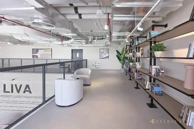 an office with a hallway with shelves of books at Chic Liva 1br Family-friendly Great Amenities in Nadd Shubayḩ