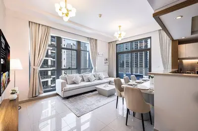 a living room with a couch and a table at Lux Unit with Burj & Fountain View I Walk Dubai Mall in Dubai