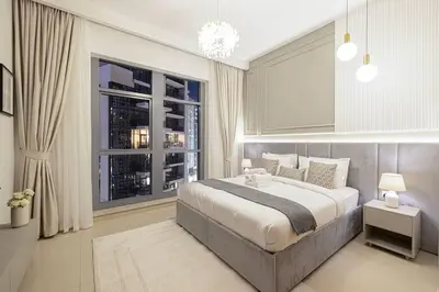 a bedroom with a large bed and a window at Lux Unit with Burj & Fountain View I Walk Dubai Mall in Dubai