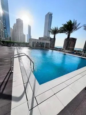 a swimming pool in the middle of a city at Stunning 1BR with Palm Jumeriah View in Marina in Dubai