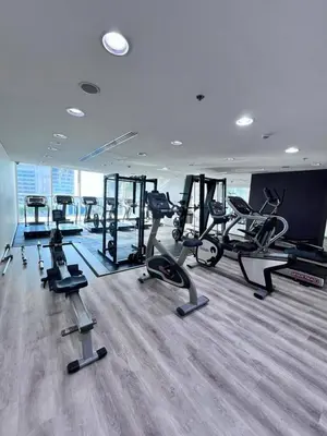 a gym with several treadmills and elliptical machines at Stunning 1BR with Palm Jumeriah View in Marina in Dubai