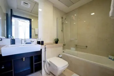 a bathroom with a sink and a toilet and a shower at Stunning 1BR with Palm Jumeriah View in Marina in Dubai