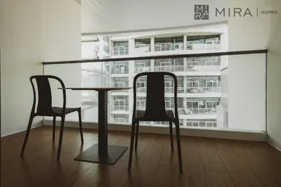 a table and two chairs in front of a window at Mira Holiday Homes - Lovely new 1 bedroom in Downtown in Dubai