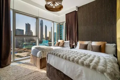 a bedroom with two beds and a large window at Prime Location Full Burj View in Downtown Dubai in Dubai