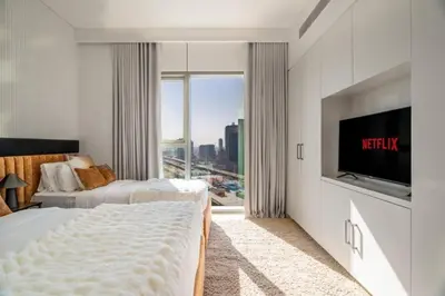 a hotel room with two beds and a large window at Prime Location Full Burj View in Downtown Dubai in Dubai